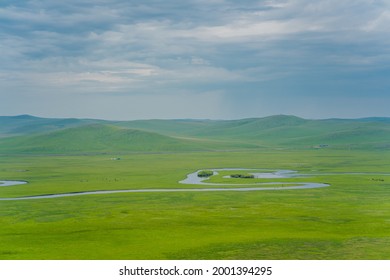 A river winding up on the Hulunbuir Grasslands, in Inner Mongolia, China, summer time.