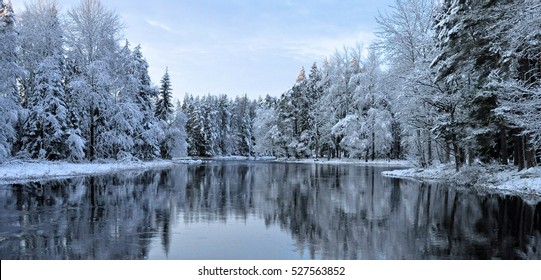 River in winter and tree branches covered with  white frost - Powered by Shutterstock