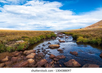 Rivers flowing down from Mount Evans summit as the summer time melt flows down hill in the high alpine tundra of the Rocky mountains of Colorado