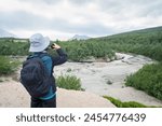 Rivers at Valley of Ten Thousand Smokes. Woman taking photos using smartphone.
Katmai National Park and Preserve. Alaska. USA.
