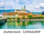 Riverside of Aare passing through Solothurn is dominated by Saint Ursus Cathedral, Switzerland
