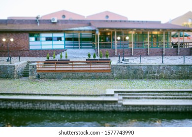 A Riverside Bar Building In Town At Dusk