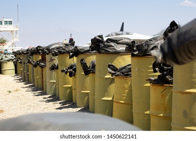 Riverside, California/United States - 06/05/2019: On A Military Base, Several Aircraft Hide Behind A Barrier Of Oil Drum Barrels