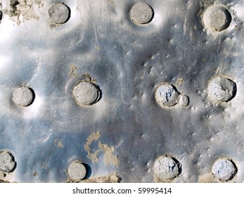 Riveted metal surface closeup background.