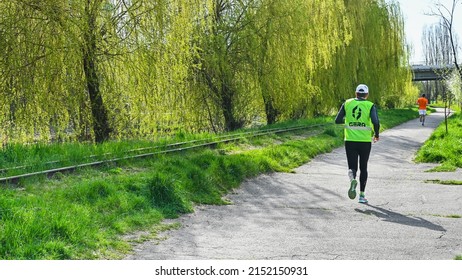 Rivne, Ukraine - May 02, 2022: local sports competitions in long-distance running in park. athletes run along the route.