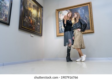 RIVNE, UKRAINE - OCTOBNER 21, 2020. Teen girl with a guide in an art gallery