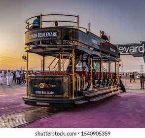 Riyadh Boulevard , In Riyadh Season - General Authority For Entertainment 23 Oct 2019 / Yellow Train With People, Walks Next To A Pink Carpet, Sun Rays Too