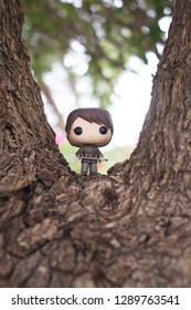 Riyadh, KSA - April 7, 2017: Game Of Thrones Character Arya Stark Portrayed Maise Williams With Her Sword By Funko Pop Vinyl Toys  In The Middle Of A Tree Bark.