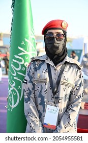 Riyadh, Saudi Arabia –September 23rd 2021: A Saudi Woman From The Saudi Army (ministry Of Interior) Standing Next To The Nation Saudi Flag.