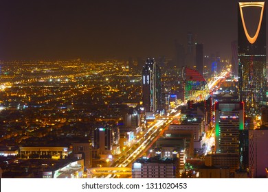 RIYADH, SAUDI ARABIA – DECEMBER 17, 2018: Panorama view to the skyline of Riyadh by night, with the Kingdom Centre in the background and yellow lighting, the capital of Saudi Arabia
