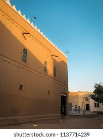 Riyadh, Saudi Arabia - July, 7 2018: Two Saudi Young Adults Walk Past King Abdulaziz Historical Center In The Capital