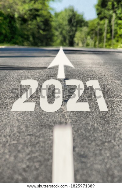 Road to 2021 year.\
Asphalt road with road markings and 2021 sign. Direction to the\
future 2021 year