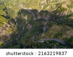 The road with 400 bends in the Cirque de Cilaos with aerial view by drone, Reunion Island