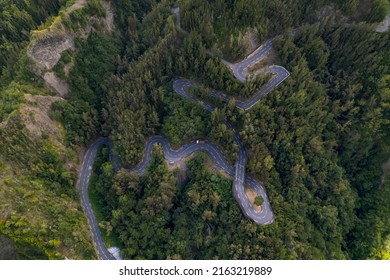 The road with 400 bends in the Cirque de Cilaos with aerial view by drone, Reunion Island