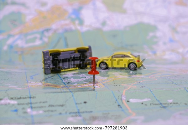  road accident. Paper map with small toy cars.\
Selective focus.