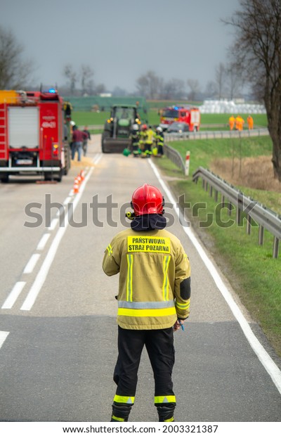 Road accident in Poland. Photo with fireman.\
Near Czarnków Poland Polska. inscription\
 in English:  fire\
brigade. Poland fireman, road\
block\
