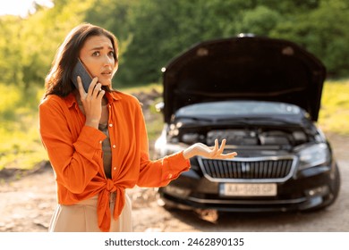 Road accident. Young European woman calling towing service on road, having phone conversation with mechanic near her broken auto - Powered by Shutterstock