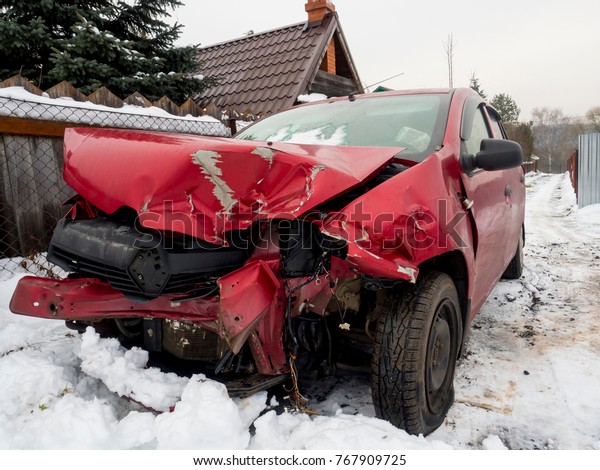 Road accidents. Red\
car in winter crushed.