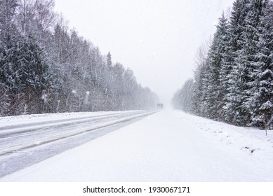 The Road Among The Forest During A Strong Snow Storm. Blurred In Motion.