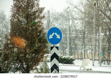 Road arrow sign on the background of snow close up
