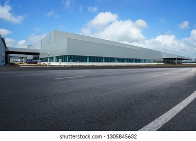 Road asphalt pavement and modern factory warehouse - Shutterstock ID 1305845632