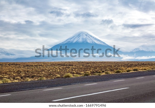 Road in Atacama desert savanna, mountains\
and volcano landscape, Chile, South\
America\
