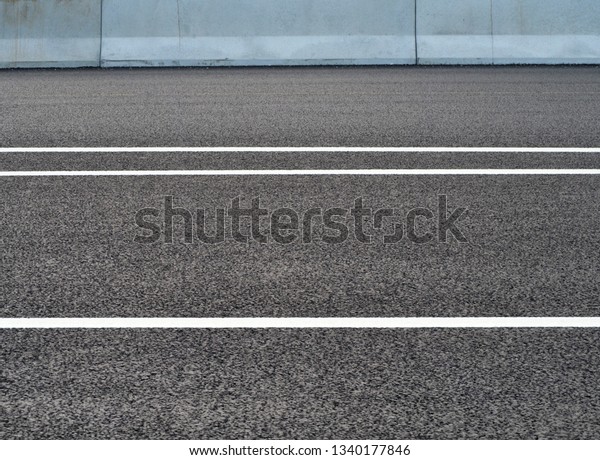 Road background.\
Barrier, designed to prevent the exit of the vehicle from the curb\
or bridge. Dividing strips