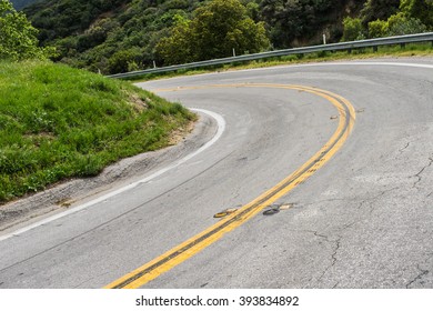 Road banks in a sharp bend in southern California mountains near Los Angeles.