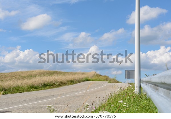 Road with barrier line and guard rail terminates\
hopelessly as a dead end