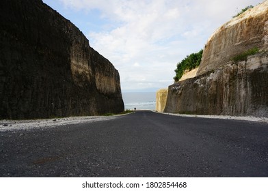 road to the beach between two cliffs