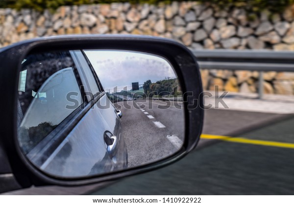 The road behind through a\
mirror