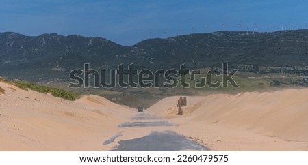 The road between the beautiful white sand dunes in Tarifa. The Valdevaqueros dune, located in the south of Spain, associated with strong easterly winds blowing in the Strait of Gibraltar. Foto stock © 