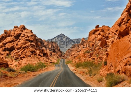 A road in between two rocks in the Valley of Fire, Nevada on a sunny day