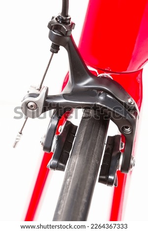 Road Bicycle Concept. Partial View of Professional Road Bike Wheel With Brake Calipers Against White. Vertical image Composition