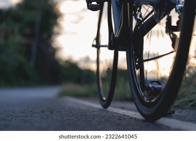Road bike parked on a beautiful road sunset, warm light with copy space.	 - Powered by Shutterstock