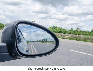 Road And Blue Sky,rear View In Car Mirror