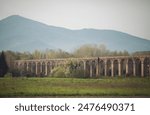 Road bridge. Roman architecture. Old stone bridge or viaduct in spring mountains. Italy.