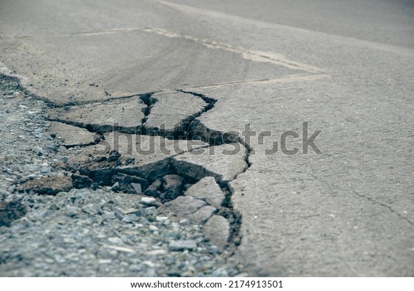 road from broken and destroyed asphalt unsuitable\
for driving
