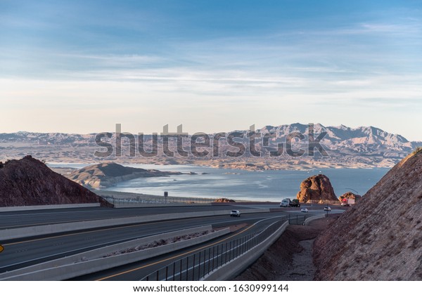 Road in California with Vehicles and\
Mountain, Lake in\
Background.