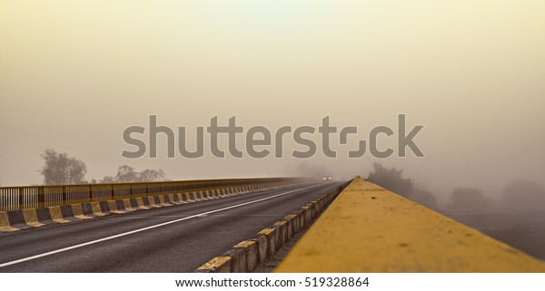 Road and a car in\
fog