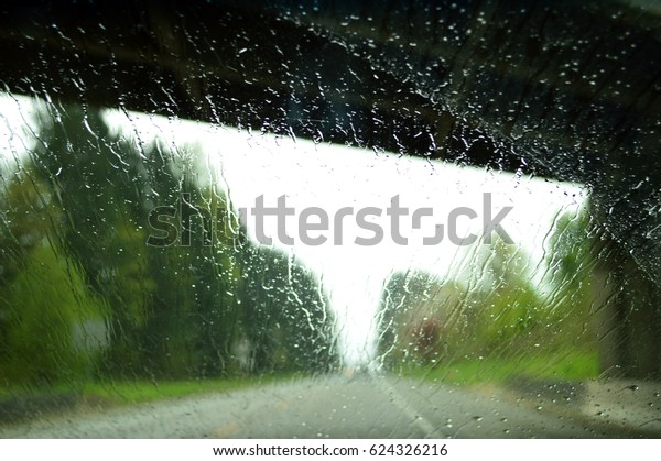 Road from the car\
in rainy day. On the way