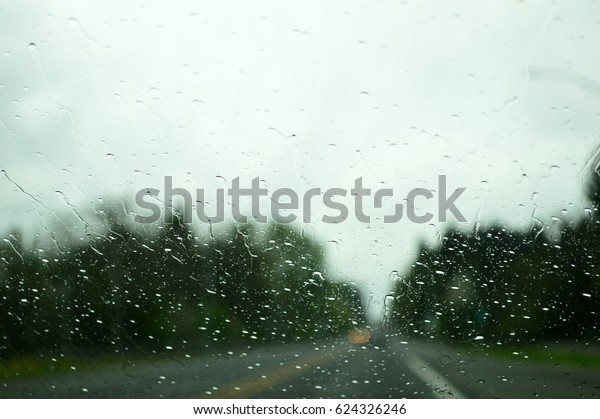 Road from the car\
in rainy day. On the way