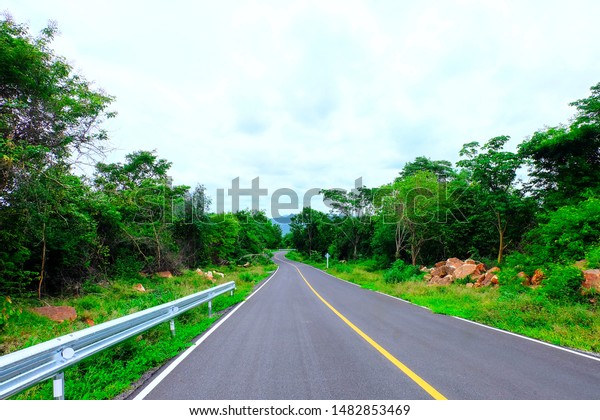Road, car route\
surrounded by nature.