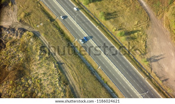 road\
for cars aerial view from top around green\
nature