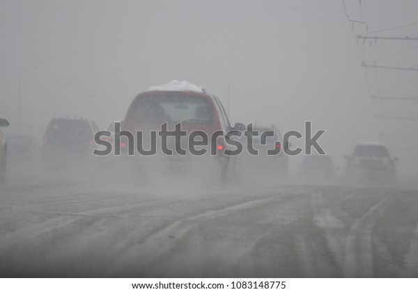 road with cars in the\
fog