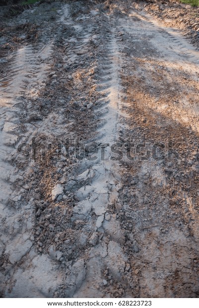Road\
with cars tire print in countryside for background\
.
