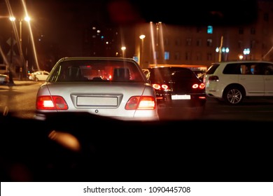 The Road In The City At The Night With Yellow And Red Electrical Light For Cars During They Are Coming Home. Rear View Of The Car At Night . Back View Of The Car At Night .