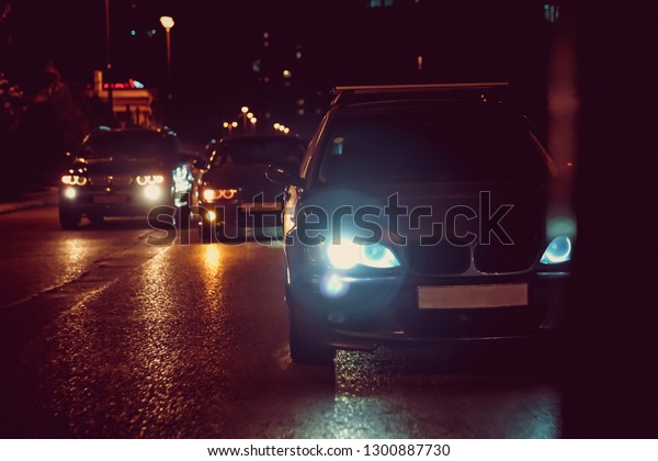 Road in the city at the night\
with yellow and red electrical light for cars during they are\
coming home. Motor cars takes part in the night street drag\
racing.