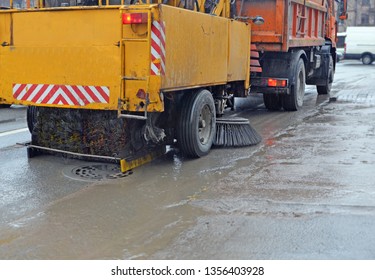 Road Cleaning Using A Sweeper Towed Bya Truck In Rainy Weather