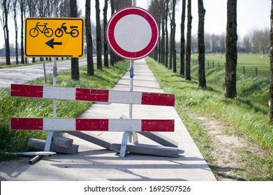 Road closed with barriers and sign for cyclists for roadworks